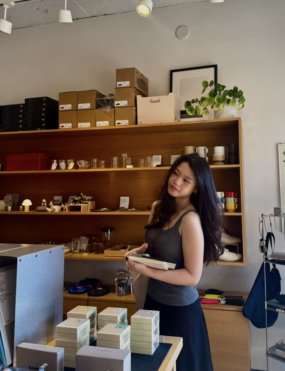 Danica browsing objects in a design shop